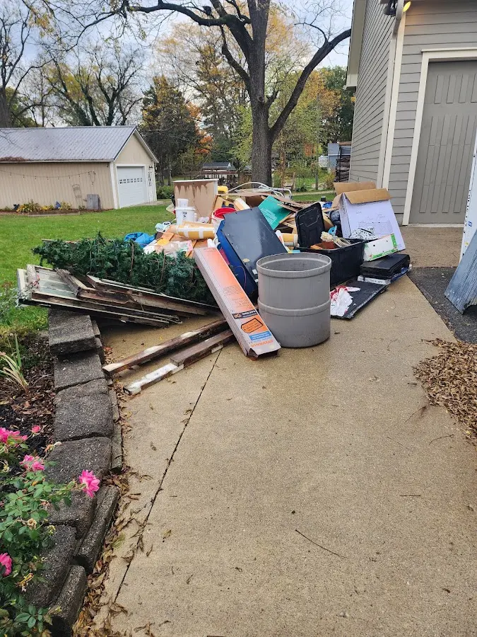 Dumpster being loaded with debris for 12 Yard Dumpster Rental in Deming
